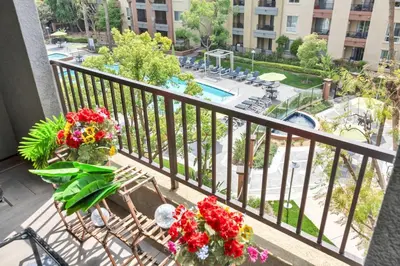 a balcony with a bench and flowers on it at Lux Oasis in Woodland Hills in Los Angeles