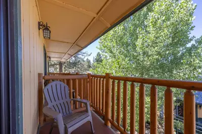 a rocking chair on the porch of a house at Big Bear Lakefront Lodge in Big Bear Lake