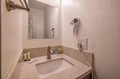 a bathroom with a sink and a phone on the wall at Big Bear Lakefront Lodge in Big Bear Lake