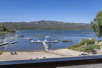 a view of a lake with a dock and boats at Big Bear Lakefront Lodge in Big Bear Lake