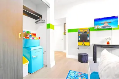 a room with a video game on the wall at B- InstaWorthy & Family-Friendly NoHo Gem- Near Universal & Hollywood with Parking, Games, and Hot Tub in North Hollywood