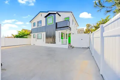 a house with a white fence and a driveway at B- InstaWorthy & Family-Friendly NoHo Gem- Near Universal & Hollywood with Parking, Games, and Hot Tub in North Hollywood