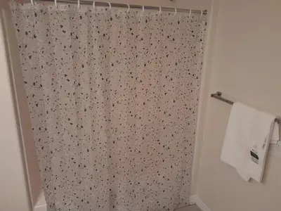 a shower with a shower curtain in a bathroom at Great place for good night rest in Anaheim