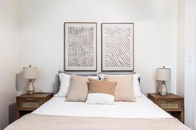 a bedroom with two pictures on the wall above a bed at 3BR Santa Monica Home, Ideal for Groups! in Los Angeles