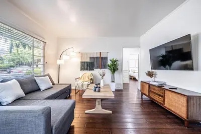 a living room with a couch and a tv at 3BR Santa Monica Home, Ideal for Groups! in Los Angeles