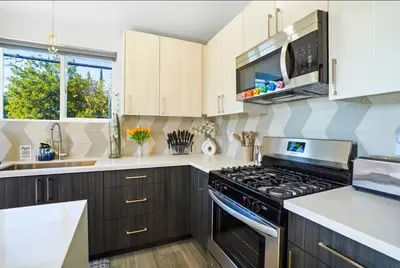 a kitchen with wooden cabinets and a stove top oven at C- Vibrant and Glam NoHo Pad near U-Studios and H-Sign in North Hollywood