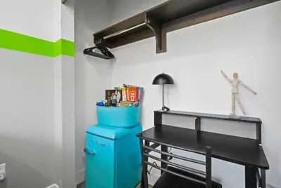 a room with a desk and a table with books at C- Vibrant and Glam NoHo Pad near U-Studios and H-Sign in North Hollywood