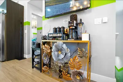 a room with a shelf with flowers on a wall at C- Vibrant and Glam NoHo Pad near U-Studios and H-Sign in North Hollywood