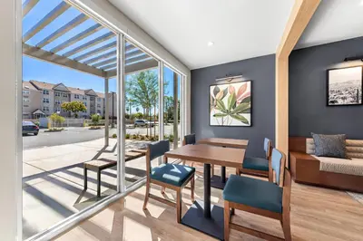 a dining room with a table and chairs at Everhome Suites San Bernardino - Loma Linda in San Bernardino