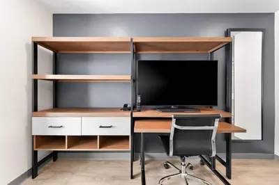 an office with a desk with a computer and a monitor at Everhome Suites San Bernardino - Loma Linda in San Bernardino