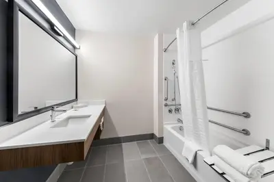a white bathroom with a sink and a shower at Everhome Suites San Bernardino - Loma Linda in San Bernardino