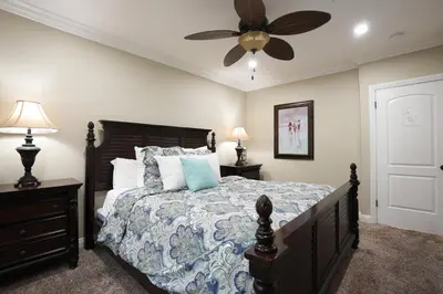 a bedroom with a bed and a ceiling fan at Highly Upgraded, 5 Bed, 45 ba, New Pool w/Jacuzzi, 1/2 mile walk to Disney in Anaheim