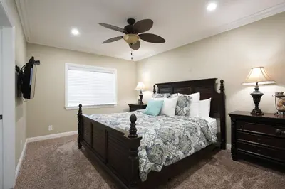 a bedroom with a bed and a ceiling fan at Highly Upgraded, 5 Bed, 45 ba, New Pool w/Jacuzzi, 1/2 mile walk to Disney in Anaheim