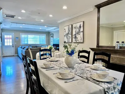 a dining room with a table with a vase on it at Stunning 8 bedroom 6 bathroom Pool Home in Anaheim
