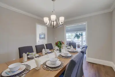 a dining room with a long table and chairs at Gorgeous Upgraded 5 Bedroom & 3 Bath Home with pool in Orange