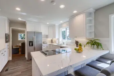 a kitchen with white cabinets and a white counter top at Gorgeous Upgraded 5 Bedroom & 3 Bath Home with pool in Orange
