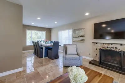 a dining room with a table and a fireplace at Beautiful Backyard Oasis 5 bedroom 3 Bathroom Home in Placentia