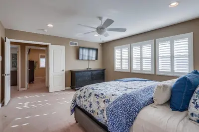 a bedroom with a bed and a ceiling fan at Beautiful Backyard Oasis 5 bedroom 3 Bathroom Home in Placentia