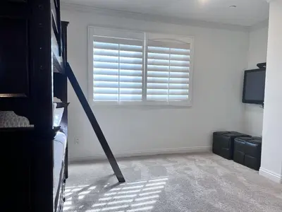 a bedroom with a window with blinds and a television at Amazing Large Family Home w/Pool, 1 Mile to Disney in Anaheim