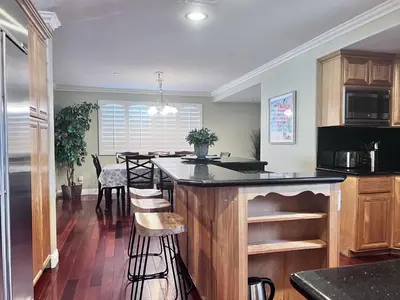 a kitchen with a island with a counter top at Amazing Large Family Home w/Pool, 1 Mile to Disney in Anaheim
