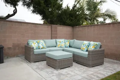 a wicker couch with pillows on a patio at Amazing Large Family Home w/Pool, 1 Mile to Disney in Anaheim