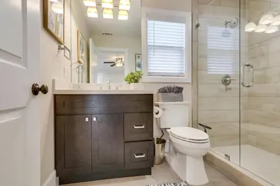a bathroom with a toilet and a sink and a shower at Gorgeous Upgraded 5 Bedroom & 4 Bath Home with Jacuzzi in Orange