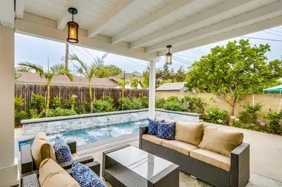 an outdoor patio with a pool and furniture at Gorgeous Upgraded 5 Bedroom & 4 Bath Home with Jacuzzi in Orange