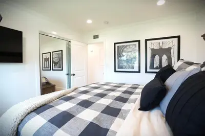 a bedroom with a black and white checkered bed at Awesome 5 bedroom 3 bath pool home with in-ground jacuzzi in Orange