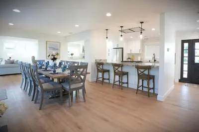 a dining room and kitchen with a table and chairs at Awesome 5 bedroom 3 bath pool home with in-ground jacuzzi in Orange