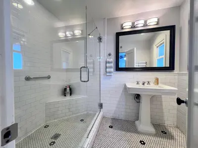 a white bathroom with a sink and a shower at Anaheim California, Beautiful Pool Home, Short Walk to Disney in Anaheim