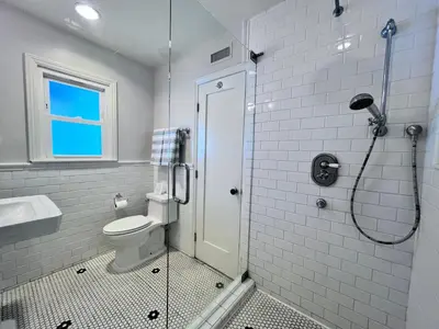 a bathroom with a shower and a toilet and a sink at Anaheim California, Beautiful Pool Home, Short Walk to Disney in Anaheim