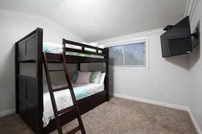 a bedroom with two bunk beds and a television at Sweet 4 bedroom, 3 bath plus Loft Bedroom, Pool Home in Anaheim