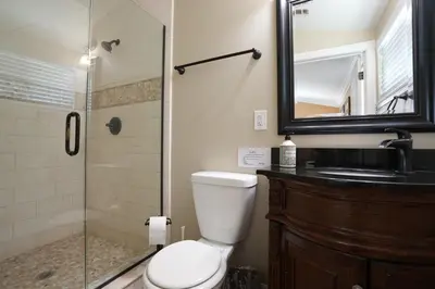 a bathroom with a shower and a toilet and a sink at Sweet 4 bedroom, 3 bath plus Loft Bedroom, Pool Home in Anaheim