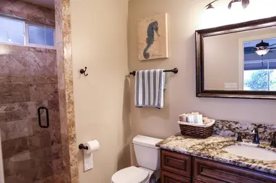 a bathroom with a toilet and a sink and a shower at Wonderful 4 Bedroom 3 Bath Pool Home 3/4 Mile To Disney in Anaheim