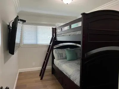 a small bedroom with a bunk bed with a bunk bedutenewayangering at Fantastic 6 bedroom, 45 bath home (4 master Suites), pool home in Anaheim