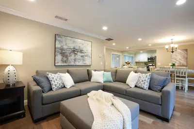 a living room with a couch and a table at Fantastic 6 bedroom, 45 bath home (4 master Suites), pool home in Anaheim