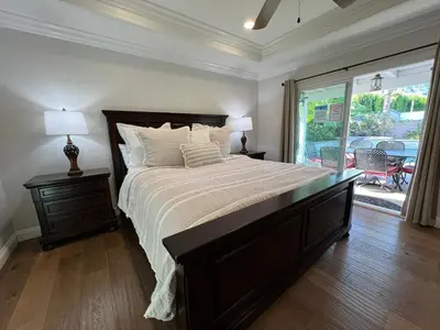 a bedroom with a large bed and a large window at Fantastic 6 bedroom, 45 bath home (4 master Suites), pool home in Anaheim