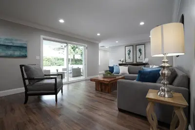 a living room with a couch and a chair at 4 bedroom, 3 bathrooms Pool Home in Orange