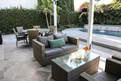 a patio with a couch and a table and a pool at 4 bedroom, 3 bathrooms Pool Home in Orange