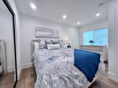 a bedroom with a bed and a window at 4 bedroom, 2 bathrooms in Orange