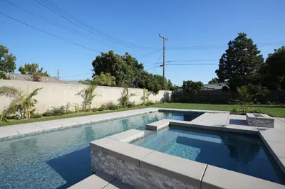 a swimming pool in the backyard of a house at 4 bedroom, 2 bathrooms in Orange