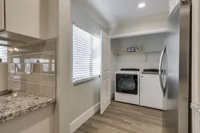 a laundry room with a white washer and dryer at 5 Bedroom plus loft room, 3 Bath home in Fullerton