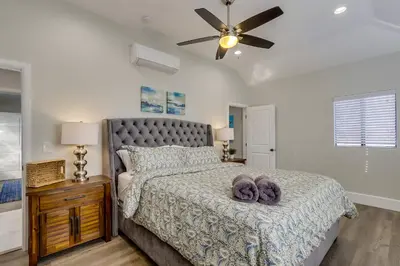 a bedroom with a bed and a ceiling fan at 5 Bedroom plus loft room, 3 Bath home in Fullerton