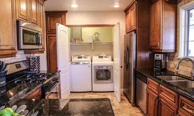 a kitchen with a white refrigerator and a dishwasher at Charming Anaheim Home 1/2 Mile Walk to Disney in Anaheim