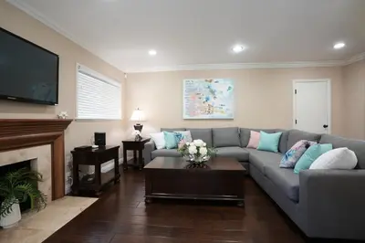a living room with a couch and a fireplace at Charming Anaheim Home 1/2 Mile Walk to Disney in Anaheim