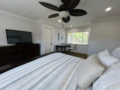 a bedroom with a bed and a ceiling fan at Gorgeous Pool Home 1/2 Mile Walk to Disney in Anaheim