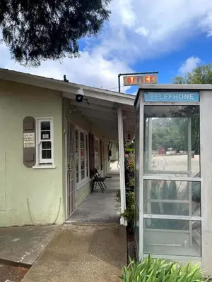 an entrance to a building with a sign that reads telephone at Sierra Pelona Motel in Santa Clarita