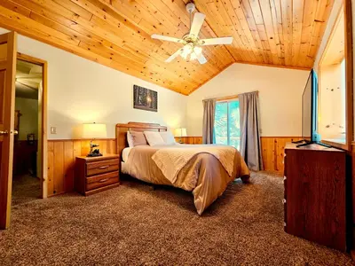 a bedroom with a bed and a ceiling fan at 3BR Home w Game Room by The Village, Lake & Summit in Big Bear Lake