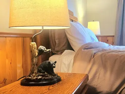 a lamp sitting on a table next to a bed at 3BR Home w Game Room by The Village, Lake & Summit in Big Bear Lake