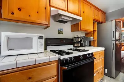 a kitchen with a microwave and a stove at 3BR Home w Game Room by The Village, Lake & Summit in Big Bear Lake